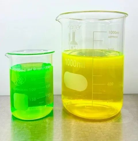 Green and yellow liquids in beakers