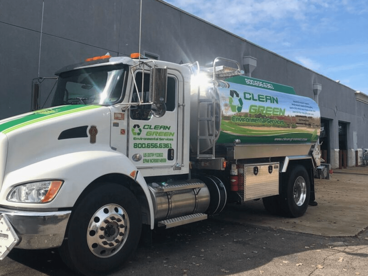 Green energy service truck parked outside