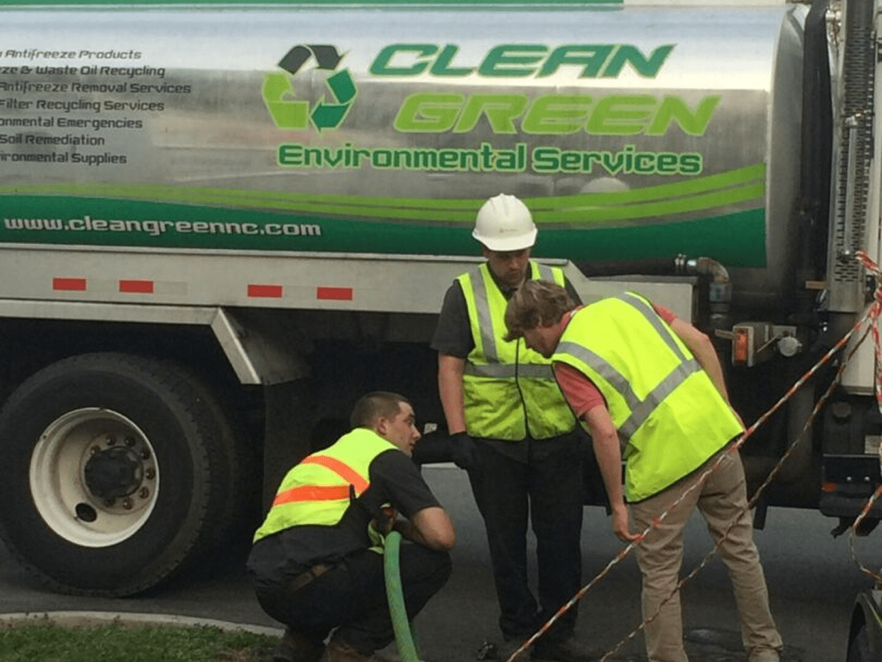 Workers in front of environmental services truck